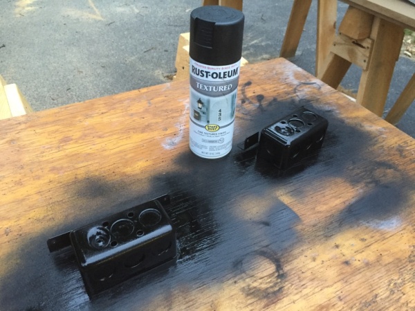 Spray painting the two visible outlet boxes black.