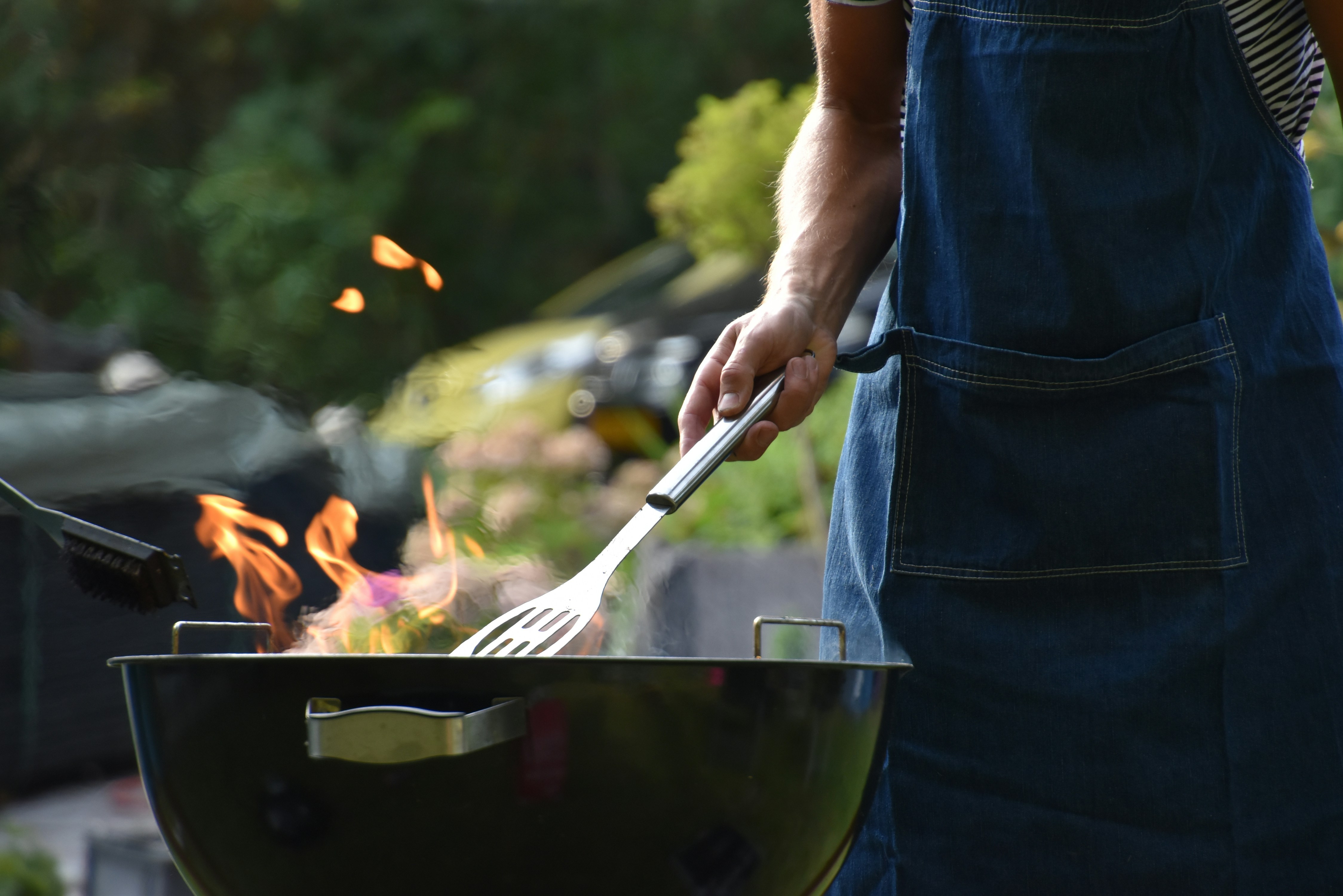 A man engaging in outdoor grilling, an image that aligns well with the section discussing the essential cooking techniques on a gas barbecue.