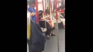 Woman on Hong Kong subway melts down when her phone battery dies.